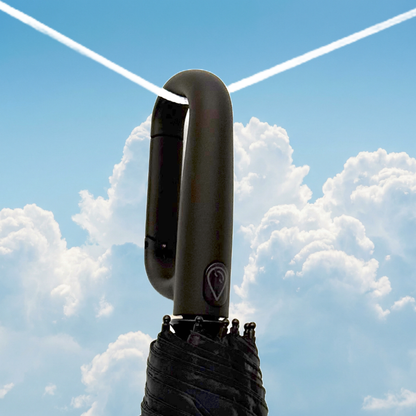 Black clip umbrella handle with a logo against a blue sky with clouds