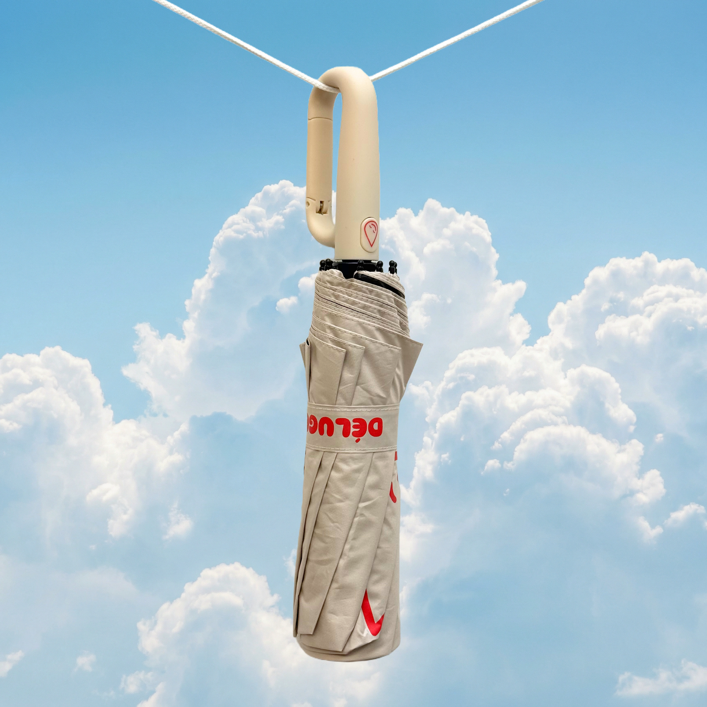 Cream umbrella with a brand logo against a blue sky with clouds
