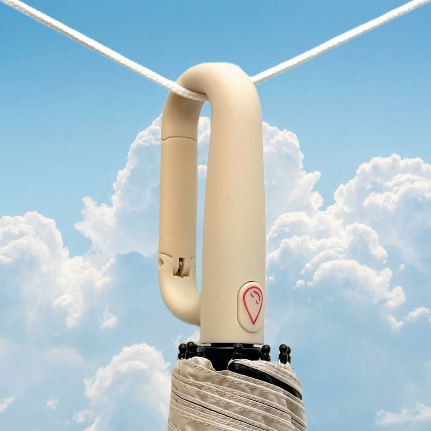 Cream umbrella handle with the deluge symbol against a blue sky with clouds