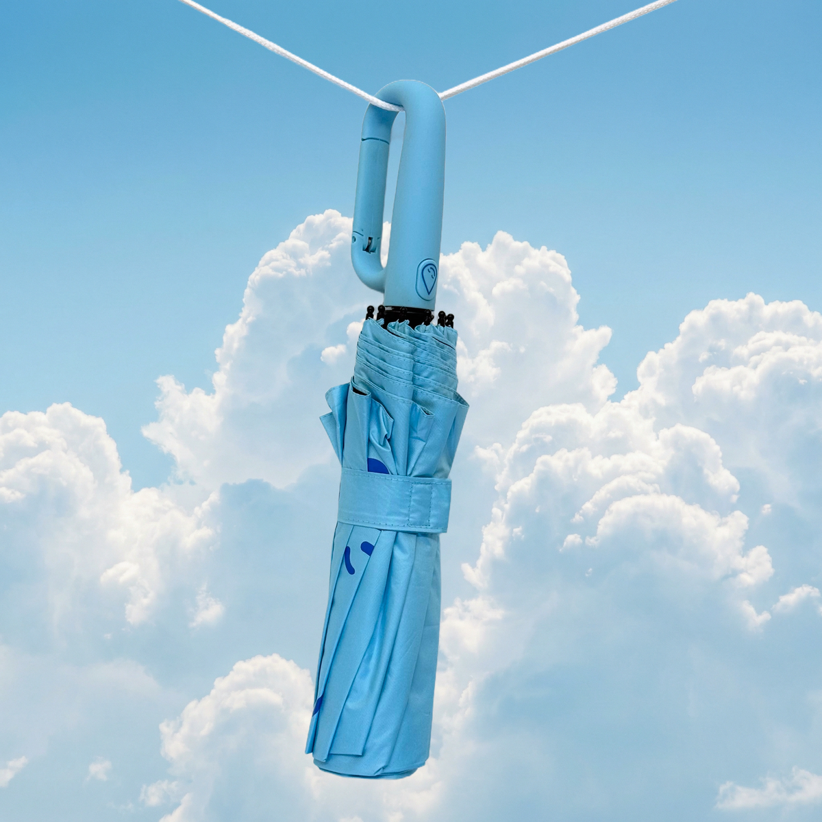 Topaz umbrella hanging against a blue sky with clouds
