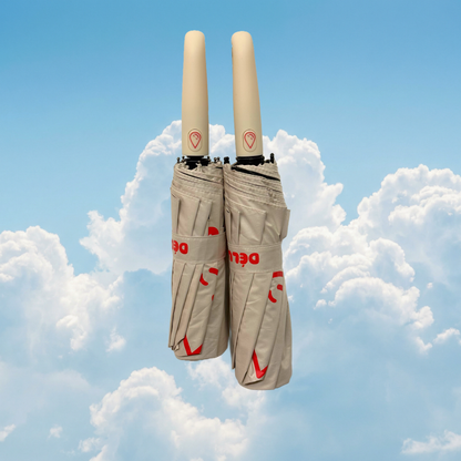 Two cream umbrellas placed next to each other against a cloudy sky backdrop