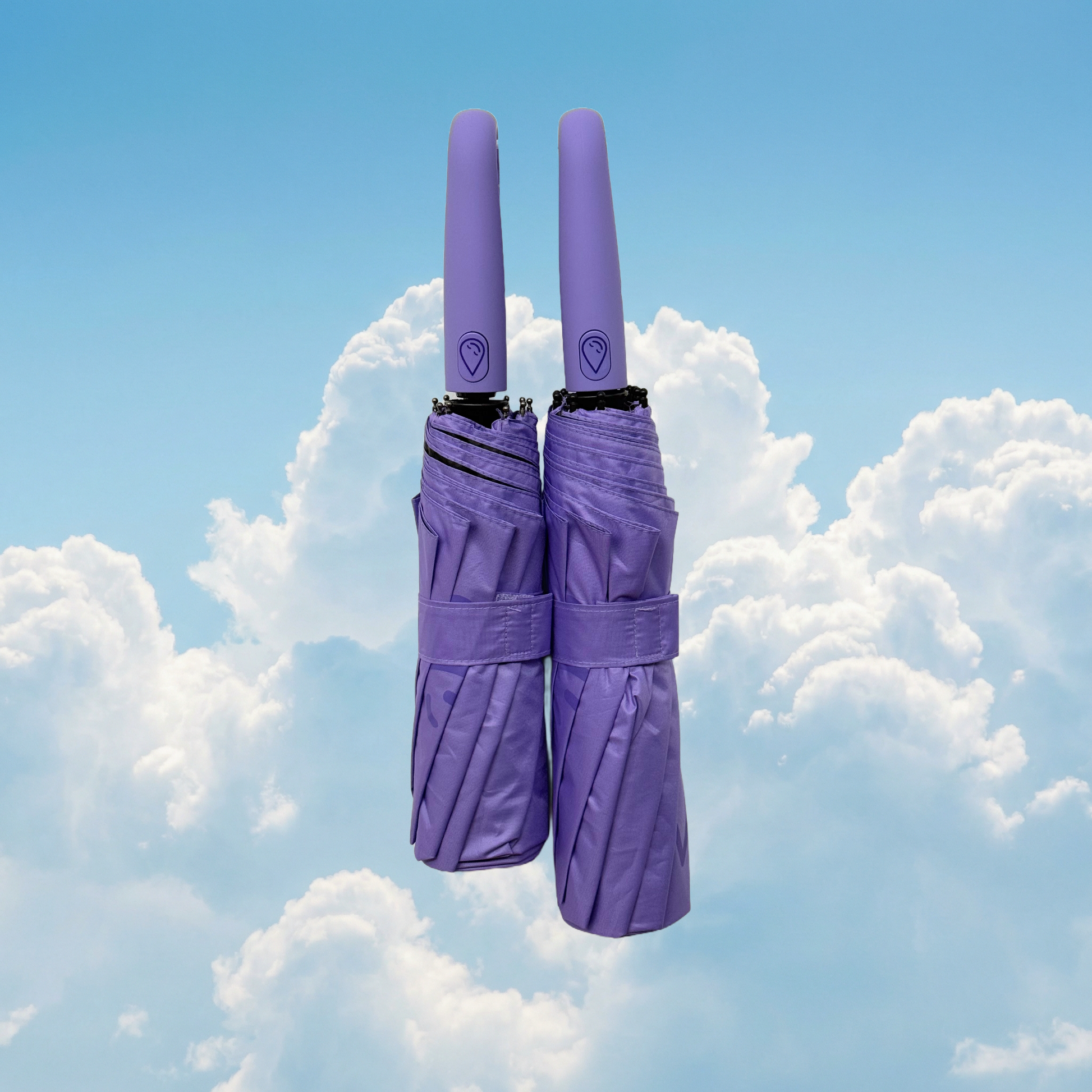 Two lilac umbrellas stacked against a blue sky with clouds