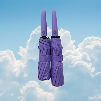 Two lilac umbrellas stacked against a blue sky with clouds