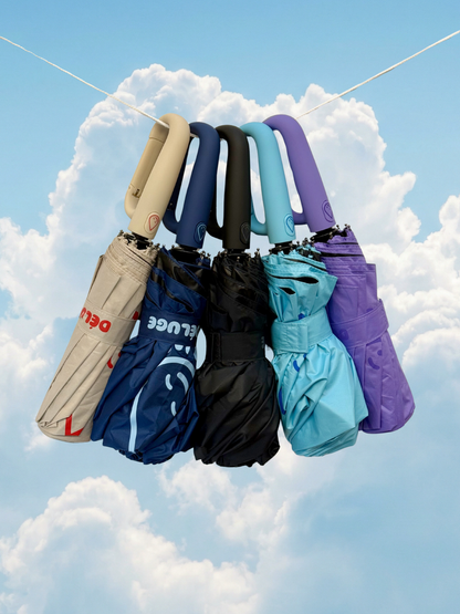 Set of folded umbrellas hanging against a blue sky with clouds